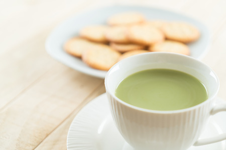 hot matcha latte on woodの写真素材