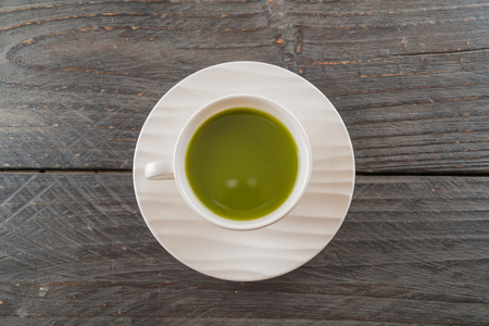 hot matcha on wood backgroundの写真素材