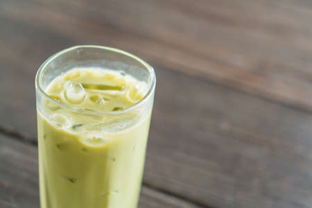 iced matcha latte on wood background