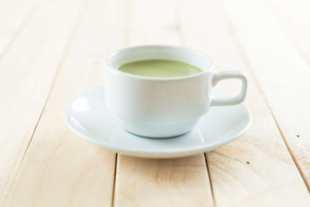 hot matcha latte on wood