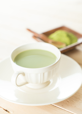hot matcha latte on woodの写真素材