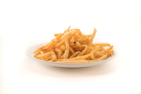 Golden French fries potatoes on whiteの写真素材