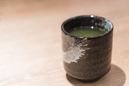 hot matcha on wood tableの写真素材