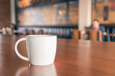 coffee cup in cafe - soft focus with vintage effect picture style