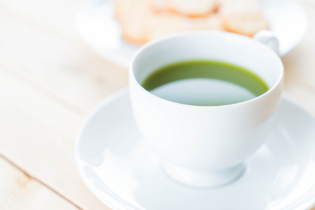 hot matcha on wood background - soft focus with vintage film filterの写真素材