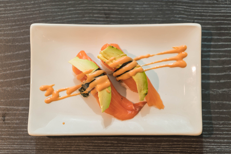 salmon avocado nigiri - japanese foodの写真素材