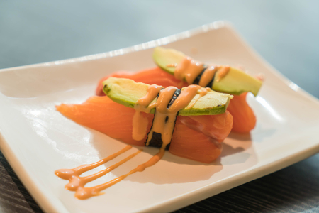 salmon avocado nigiri - japanese foodの写真素材
