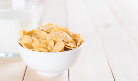 milk and cereal on wood table