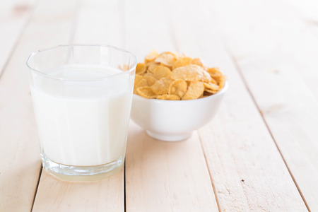 milk and cereal on wood tableの写真素材
