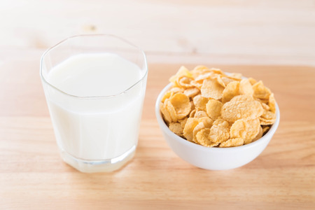 milk and cereal on wood tableの写真素材