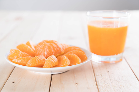 fresh orange with juice on wood tableの写真素材