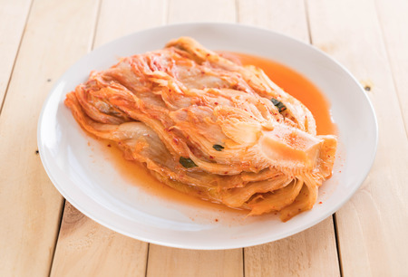 kimchi on wood background - korean foodの写真素材