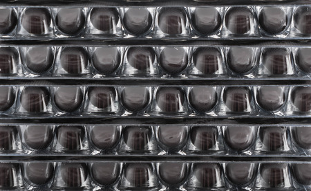 packings of pills and capsules of medicines on white background