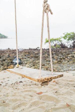 white swing on a beachの写真素材