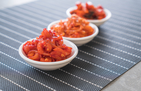 Chinese cabbage, squid and radish kimchi on the tableの写真素材