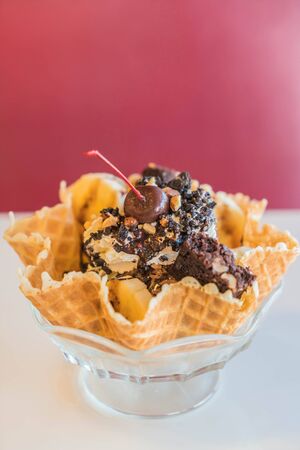 Ice Cream Sundae in an edible waffle bowl with browniesの写真素材