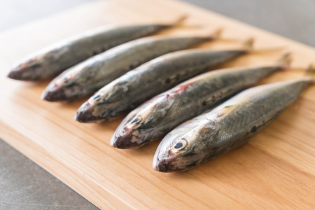 fresh mackerel on wood boardの写真素材