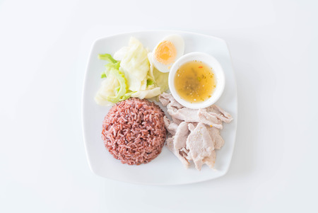 Steamed pork with spicy sauce and lemon with berry riceの写真素材