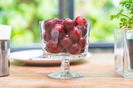 cherry in bowl on dinning tableの写真素材
