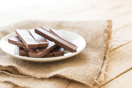 chocolate bars on wood backgroundの写真素材
