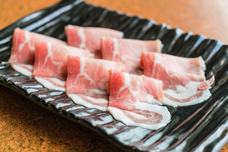 Slide raw meat on the tableの写真素材