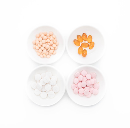 Colorful capsules and pills on plateの写真素材