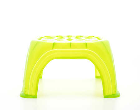 Small green plastic stool on white background