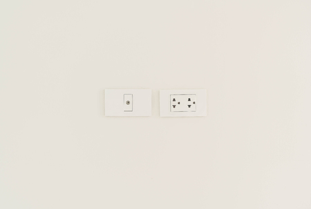 White electric socket on the wall.