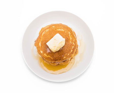 cheese on pancake stack with honey on white backgroundの写真素材