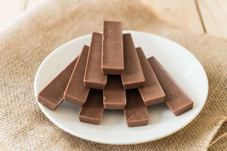 chocolate bars on wood backgroundの写真素材