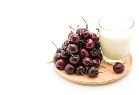 fresh cherry with milk on wood plate on whiteの写真素材
