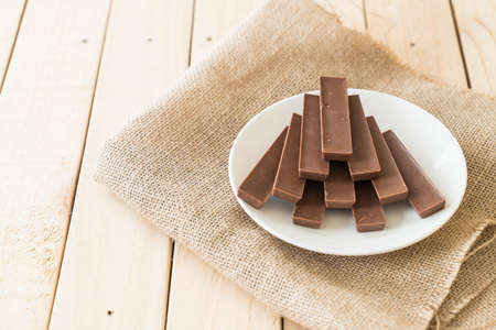 chocolate bars on wood backgroundの写真素材
