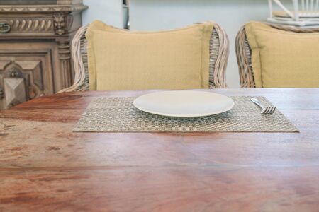 Empty dish spoon and fork on grungy wood tableの写真素材