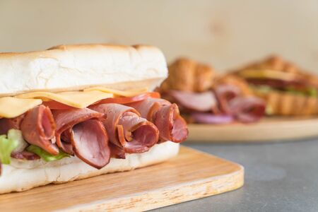 Ham and salad submarine sandwich on table backgroundの写真素材