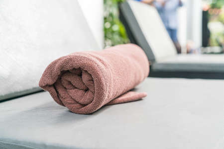 Pool towel on chair decoration around swimming pool in hotel resortの写真素材