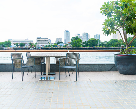 chair at terrace restaurant with city view backgroundの写真素材