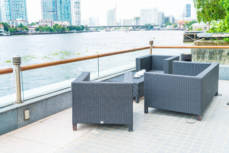 Outdoor patio with empty chair and tableの写真素材