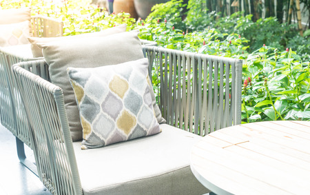 Patio outdoor deck with pillow on chair decoration exterior of home - Vintage light filterの写真素材