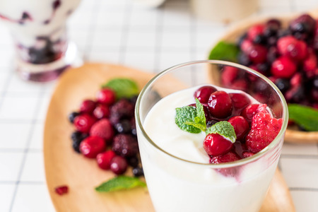 yogurt with mixed berries on the tableの写真素材