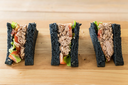 tuna charcoal  sandwich on wood tableの写真素材