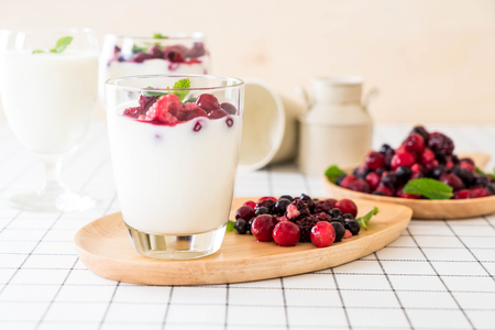 yogurt with mixed berries on the tableの写真素材