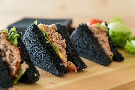 tuna charcoal  sandwich on wood tableの写真素材