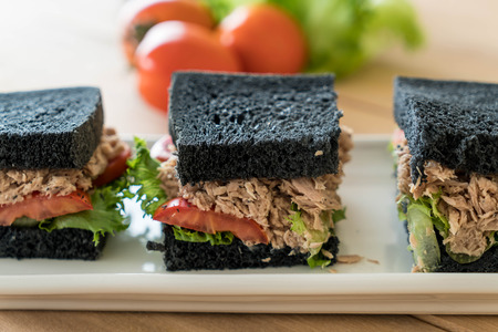 tuna charcoal  sandwich on wood tableの写真素材