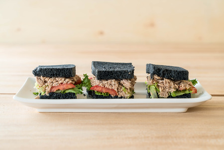 tuna charcoal  sandwich on wood tableの写真素材