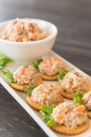 tuna spread with cracker on wood boardの写真素材