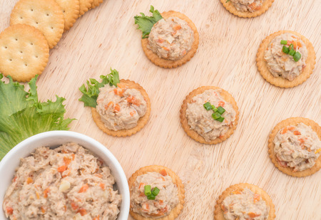 tuna spread with cracker on wood boardの写真素材