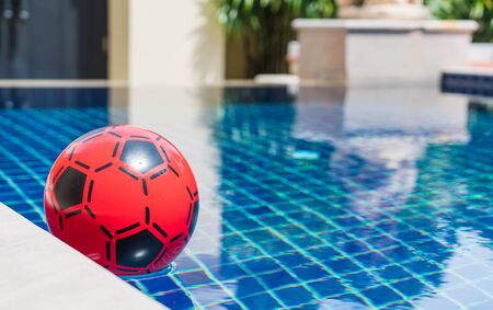 Inflatable colorful ball floating in a swimming pool