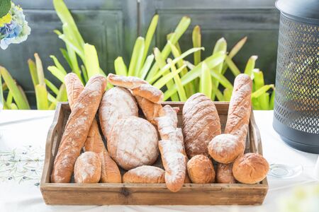Rows of fresh bread loafs lying on trayの写真素材