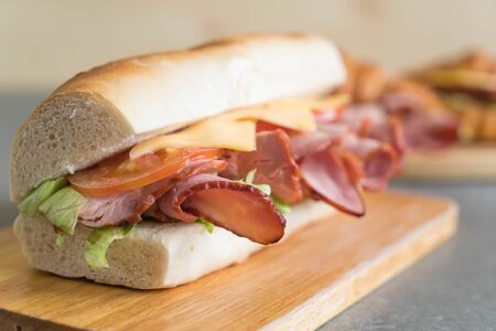 Ham and salad submarine sandwich on table backgroundの写真素材