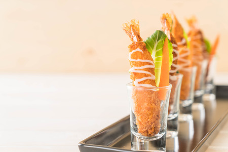 batter-fried prawns on black plate